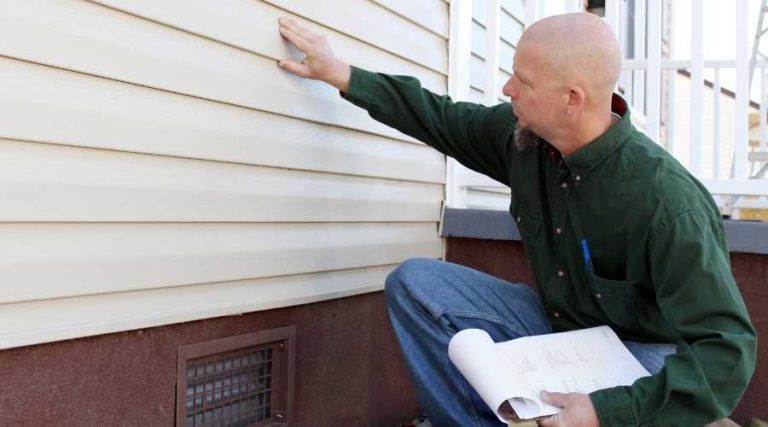 man inspecting house walls | Pest Control Carlsbad | Exterminator Carlsbad | Carlsbad Pest Control